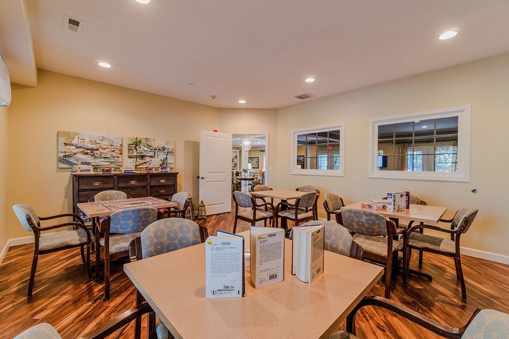Bright dining room with wooden tables, chairs, and recessed lighting in a cozy restaurant or café
