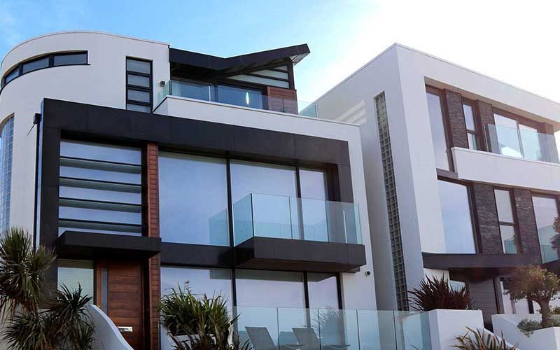 a large white and black house with a balcony
