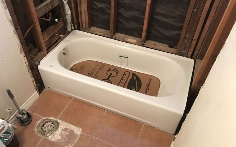a bathtub with a cardboard covering on top of it that says 100 % recycled