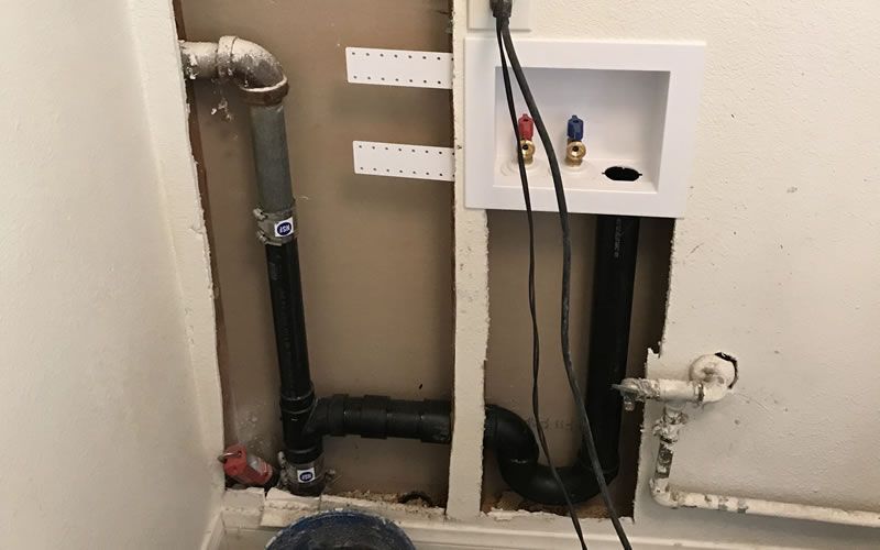 a hole in the wall has a washer and dryer hook up