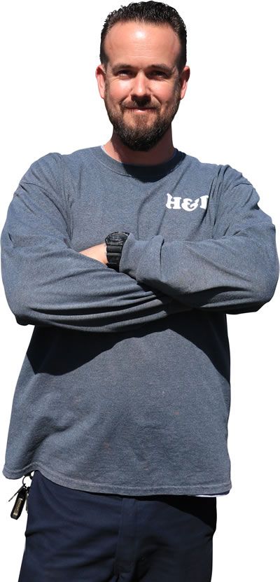 a man with his arms crossed wearing a shirt that says hei