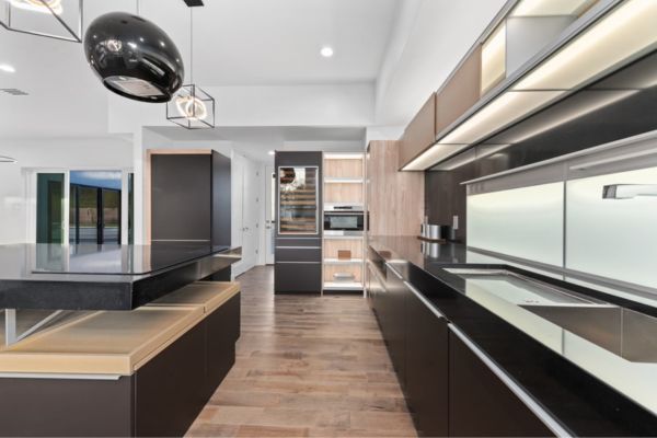 A kitchen with black cabinets and a stove top oven