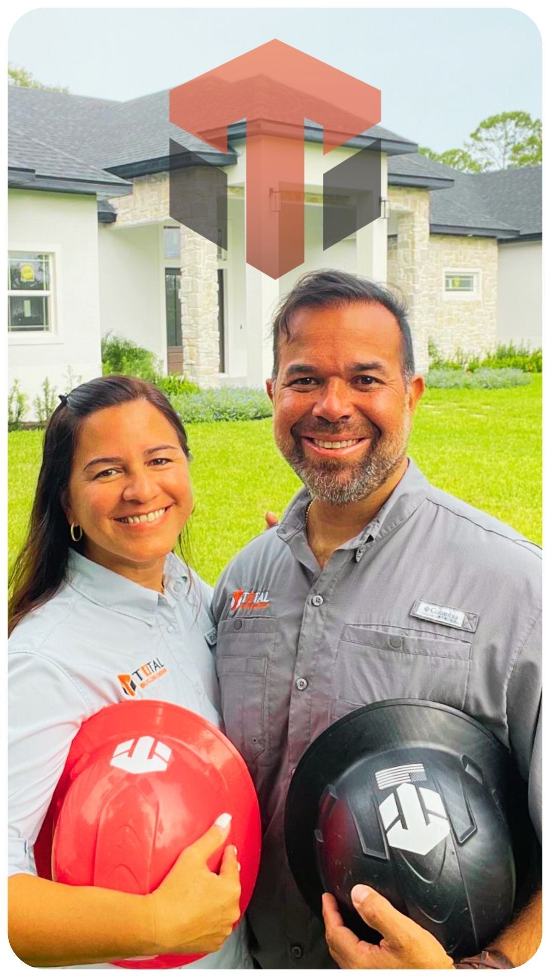 A man and a woman are holding hard hats in front of a house.