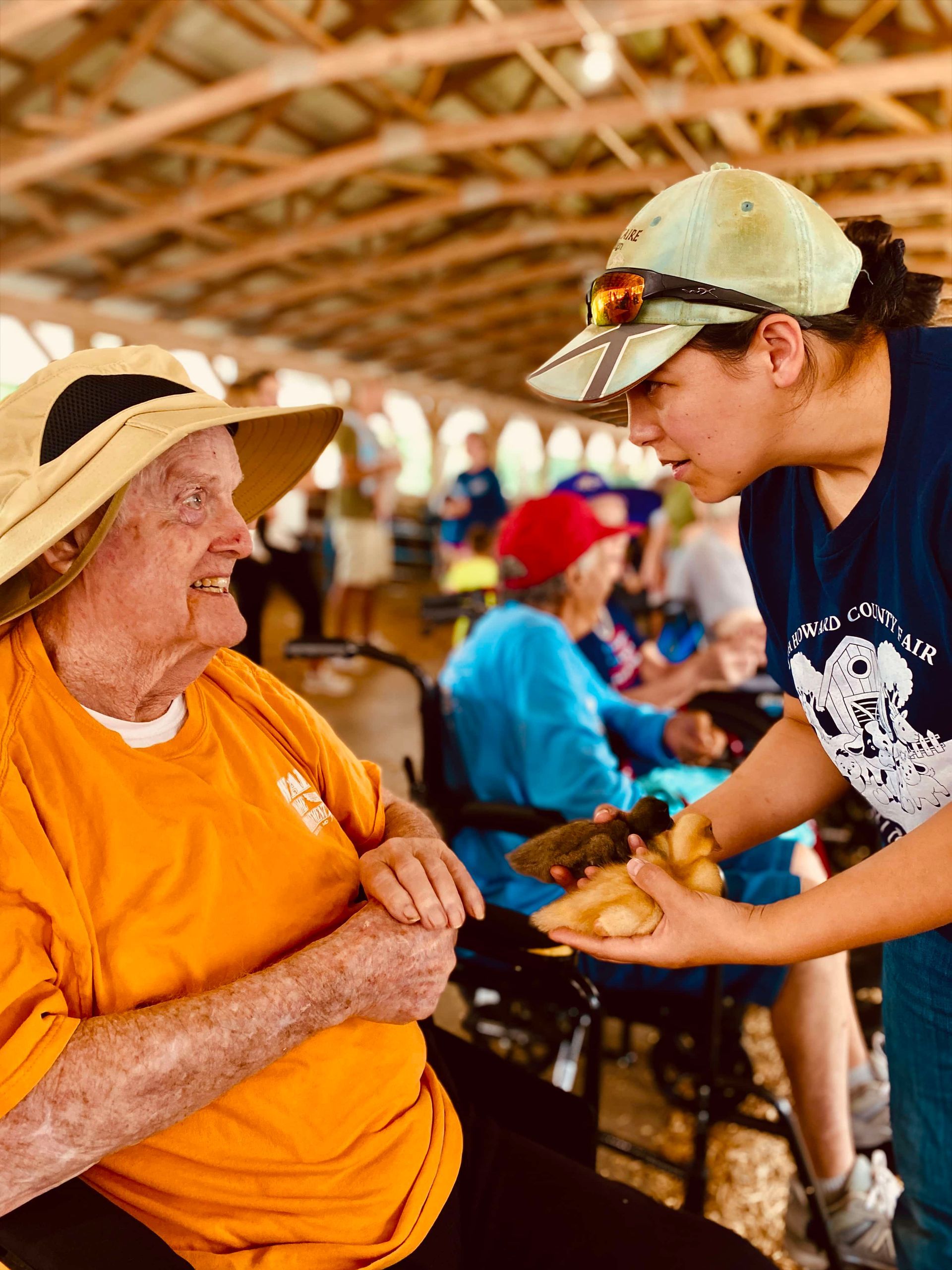 Volunteers serving food to attendees at a covered outdoor event