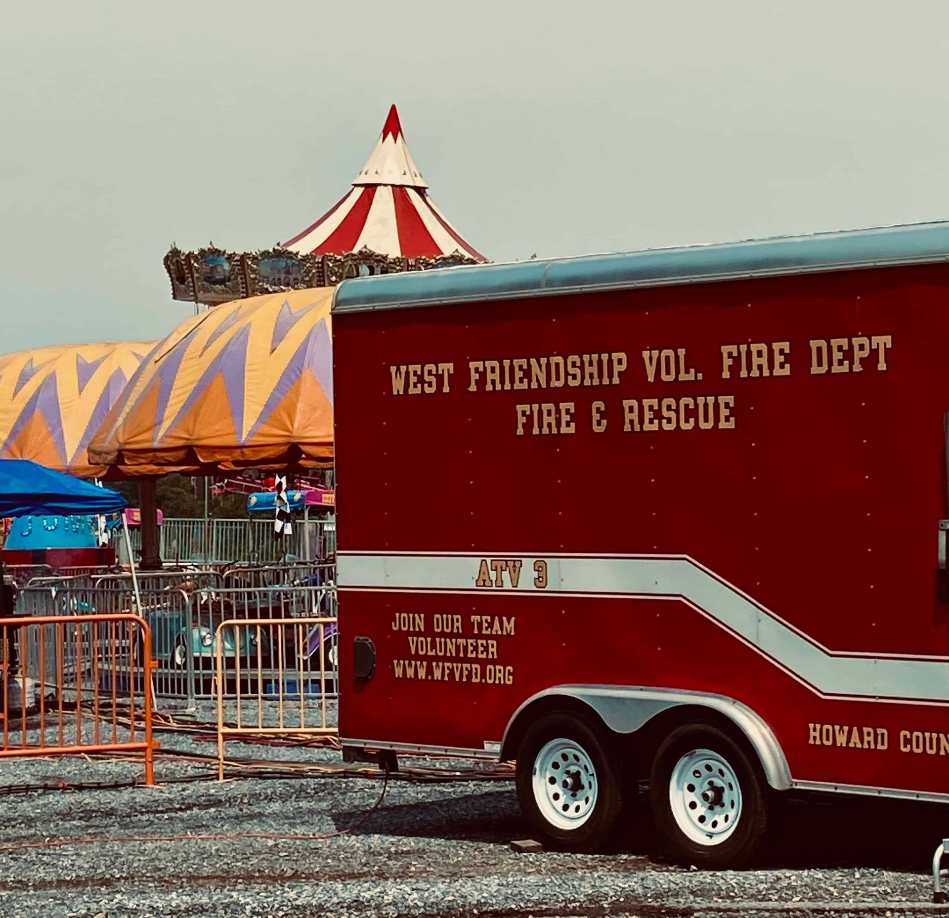 West Friendship Volunteer Fire Dept. rescue trailer beside a red-and-white carnival tent.