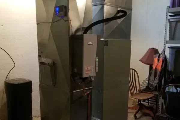 A room with a heater and a vacuum cleaner in it.