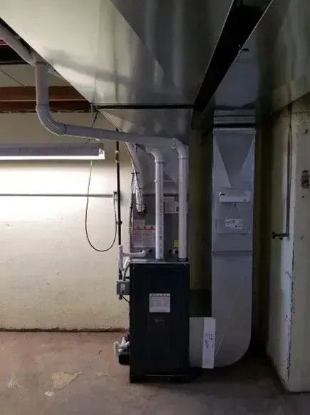 There is a heater in the corner of the room.