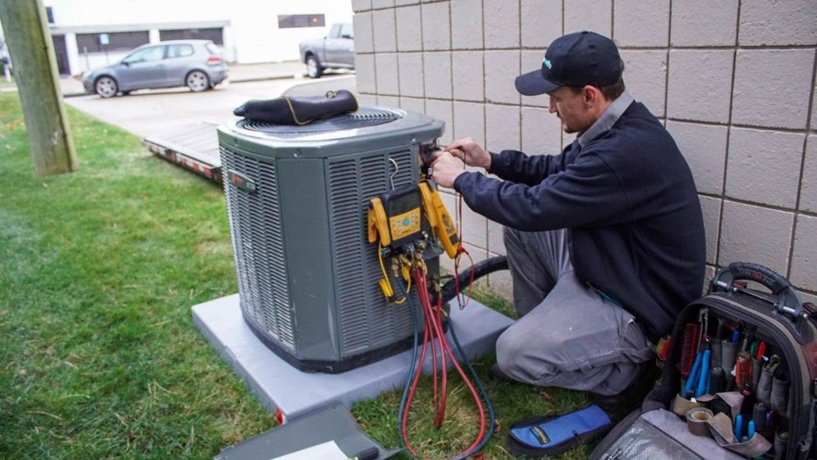 Air Conditioning Repair technician servicing a residential outdoor AC unit
