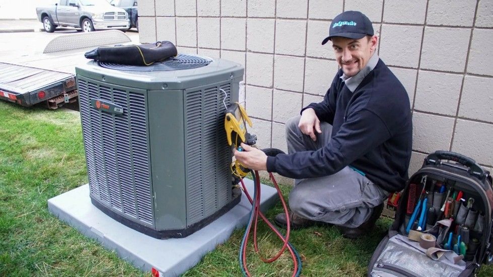 Air Conditioning Repair technician servicing an outdoor AC unit