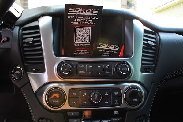The dashboard of a car with a sign that says soko 's on it