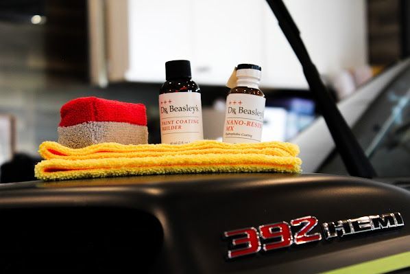 A close up of a car hood with a towel and bottles on it
