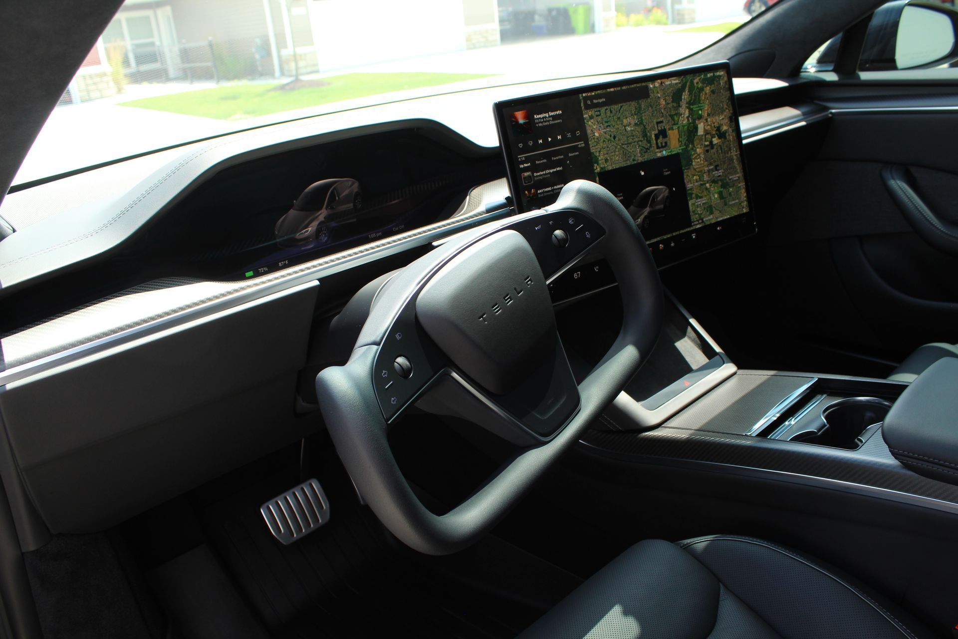 The interior of a tesla model s with a steering wheel