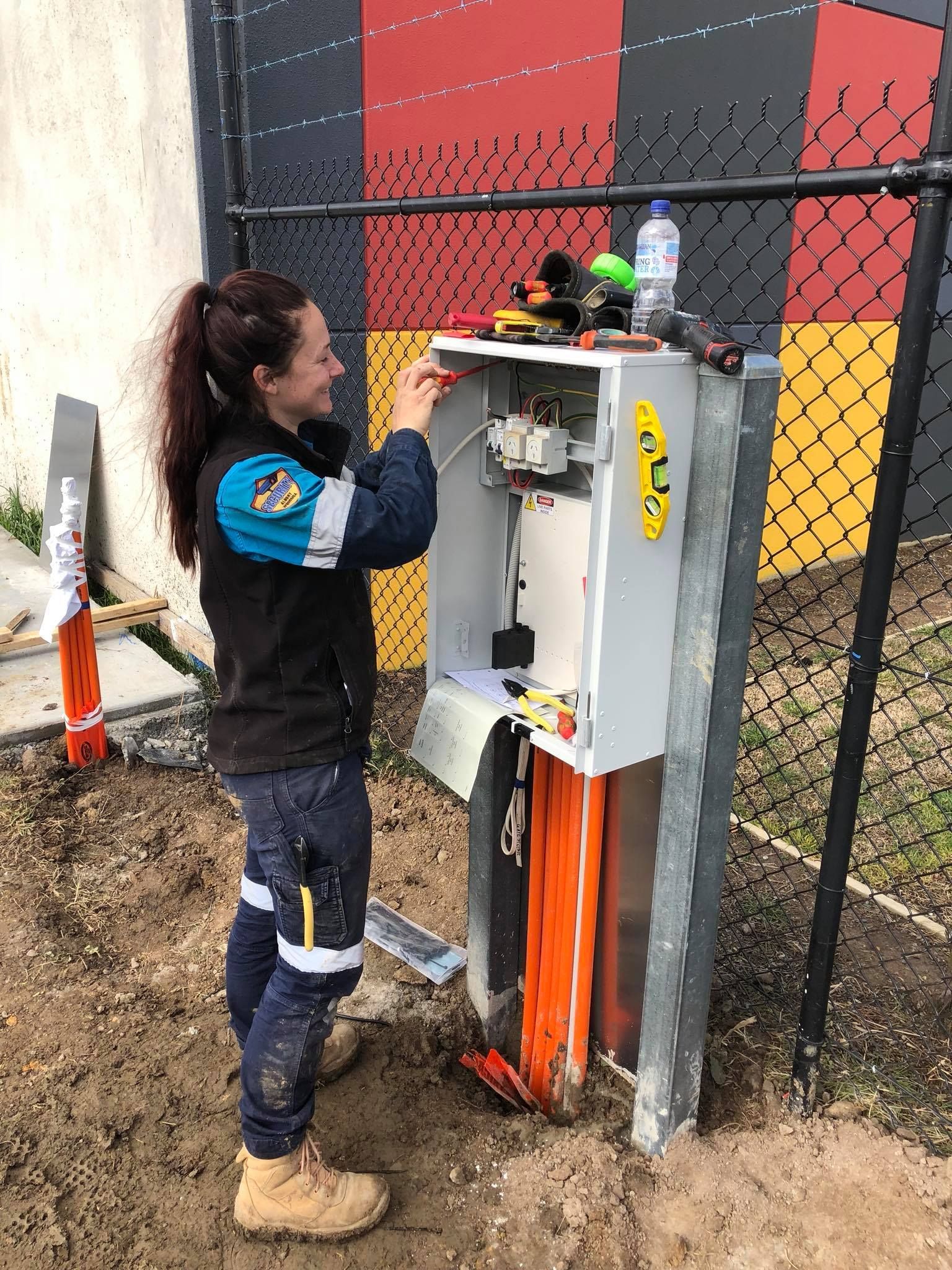 Man Adjusting Air Conditioning System — John B Electrical In Albury NSW