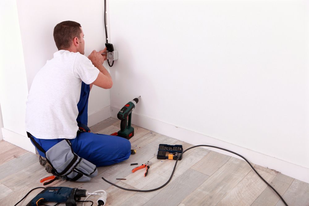 Electrician Carries Out The Wiring Of The Fuse Box Installation — John B Electrical In Wooragee VIC