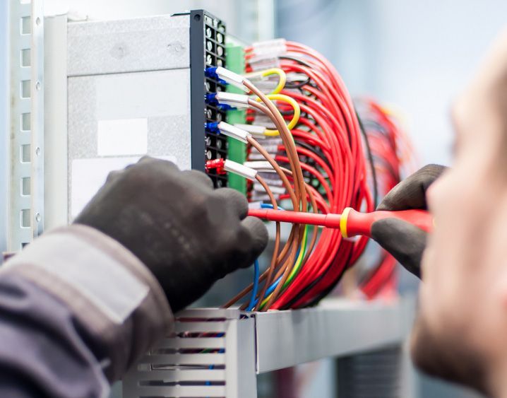 Closeup Of Electrician Works With Electric Cable Wires Of Fuse Switch Box — John B Electrical In Albury NSW