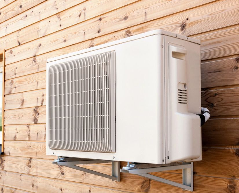 Exterior Airconditioning Unit On A Wooden Wall — John B Electrical In Albury NSW