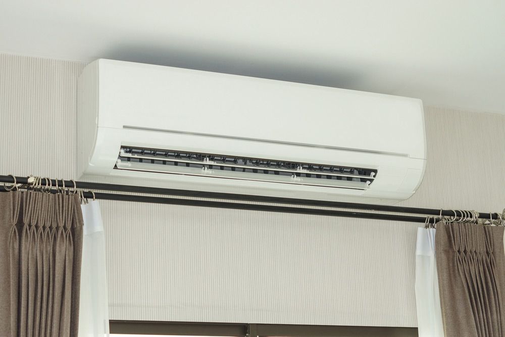 Air Conditioner Installed On The Wall Under The Ceiling — John B Electrical In Albury NSW