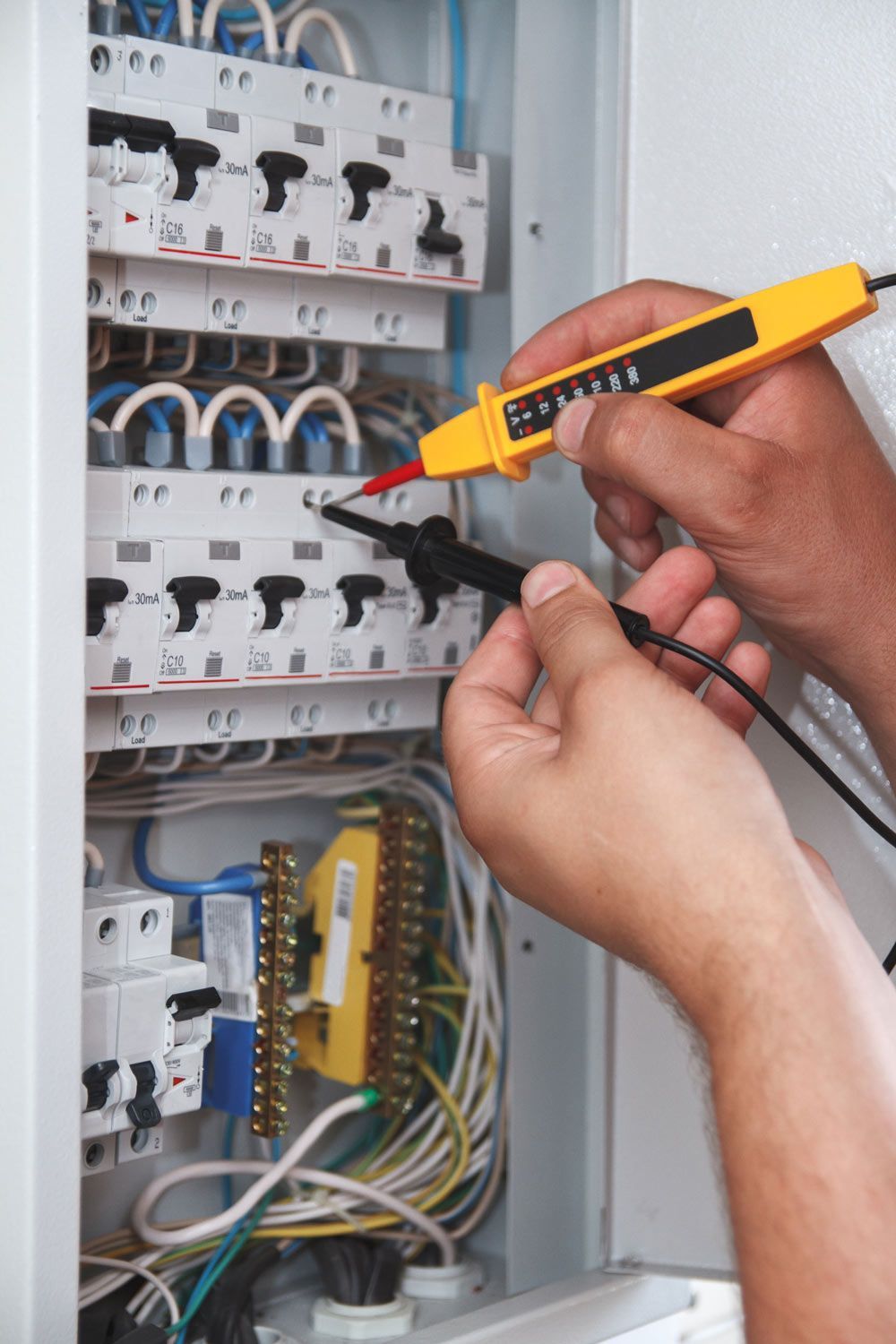 Electrician Examining Electrical Switchgear And Fuse Box — John B Electrical In Thurgoona NSW
