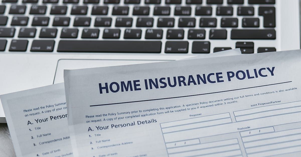 A home insurance policy is sitting on top of a laptop keyboard. D&D Construction Nottingham