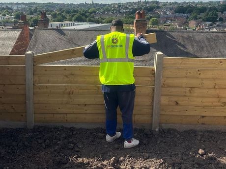 A man wearing a yellow safety vest for D&D Construction Nottingham