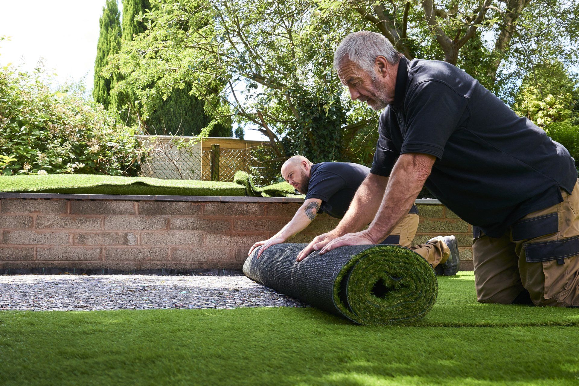 Two Workers Installing Artificial Grass - Chesapeake, VA - Western Branch Lawn & Landscapes