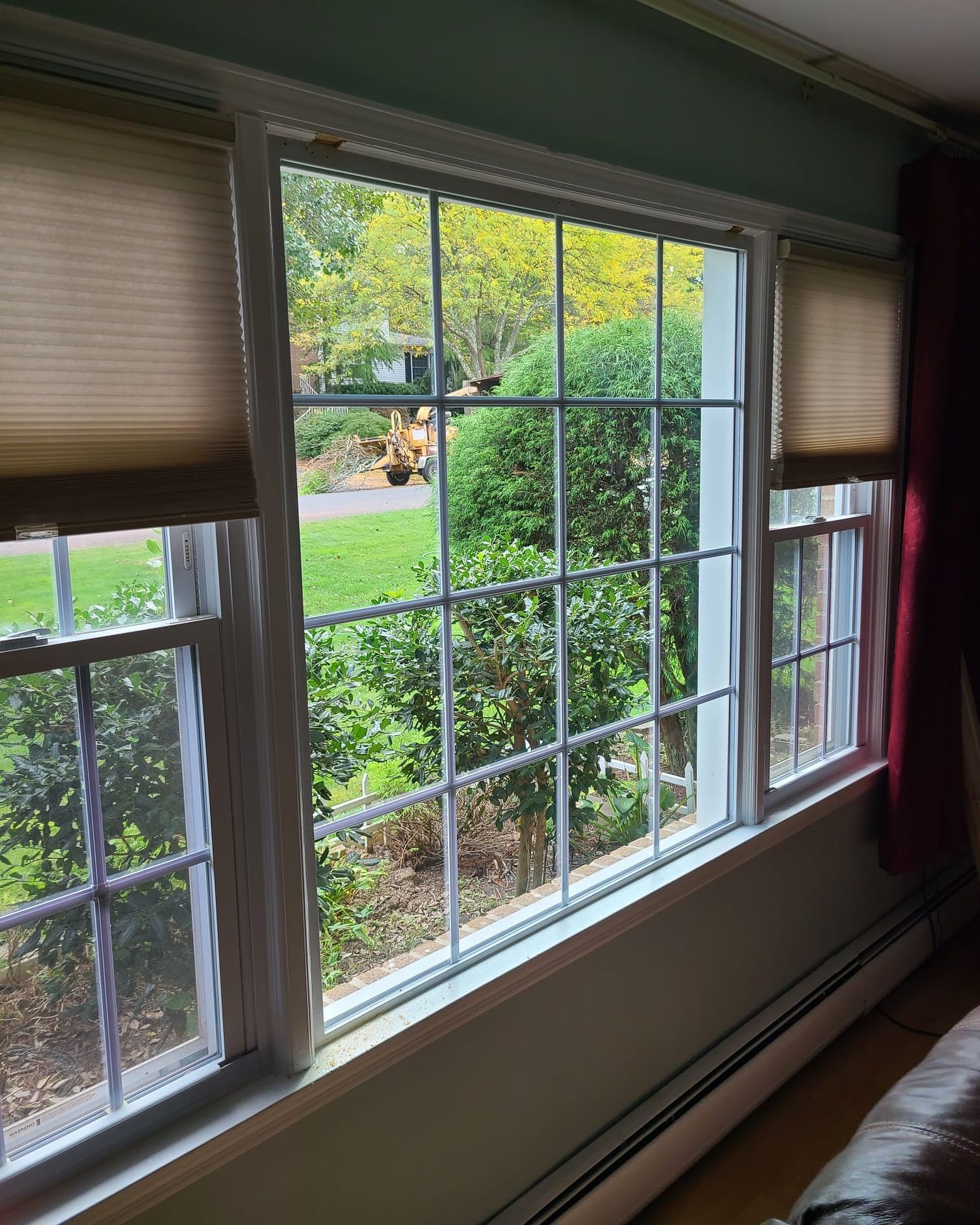 A living room with a lot of windows and a couch
