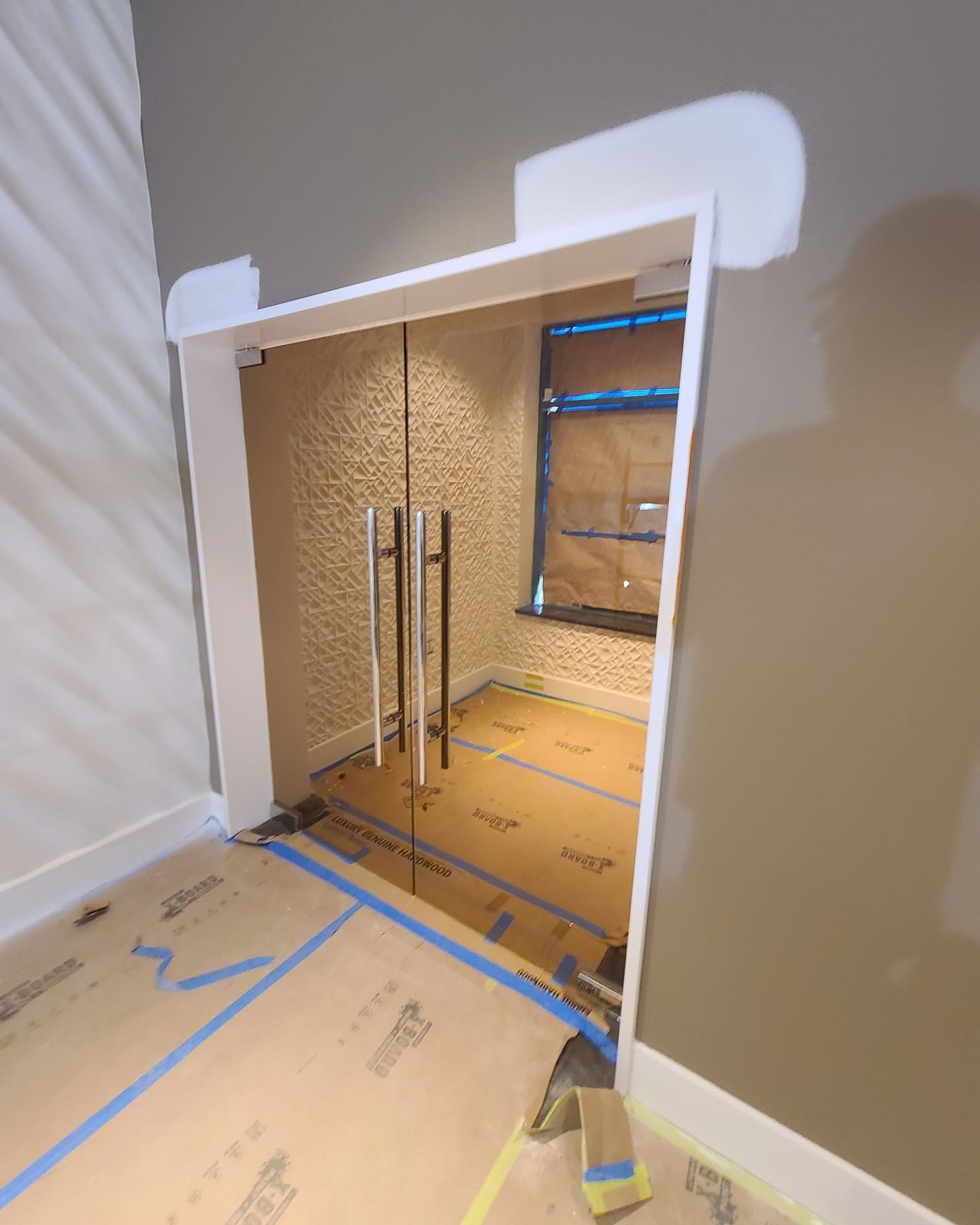A room with a glass door and a window