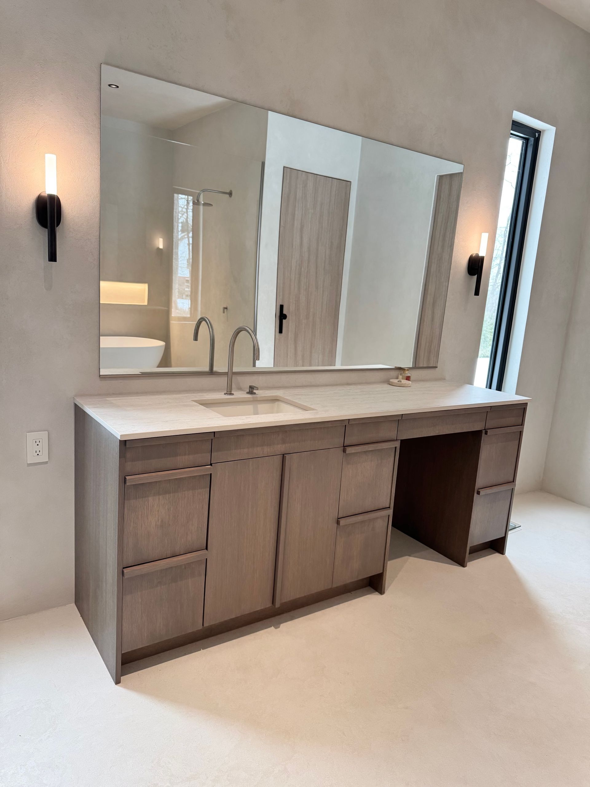 A bathroom with two sinks and a large mirror