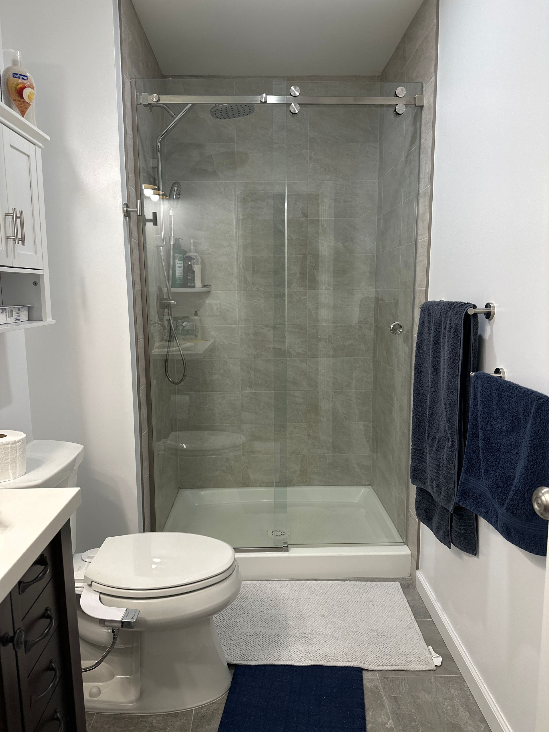 A bathroom with a toilet , sink , and shower.