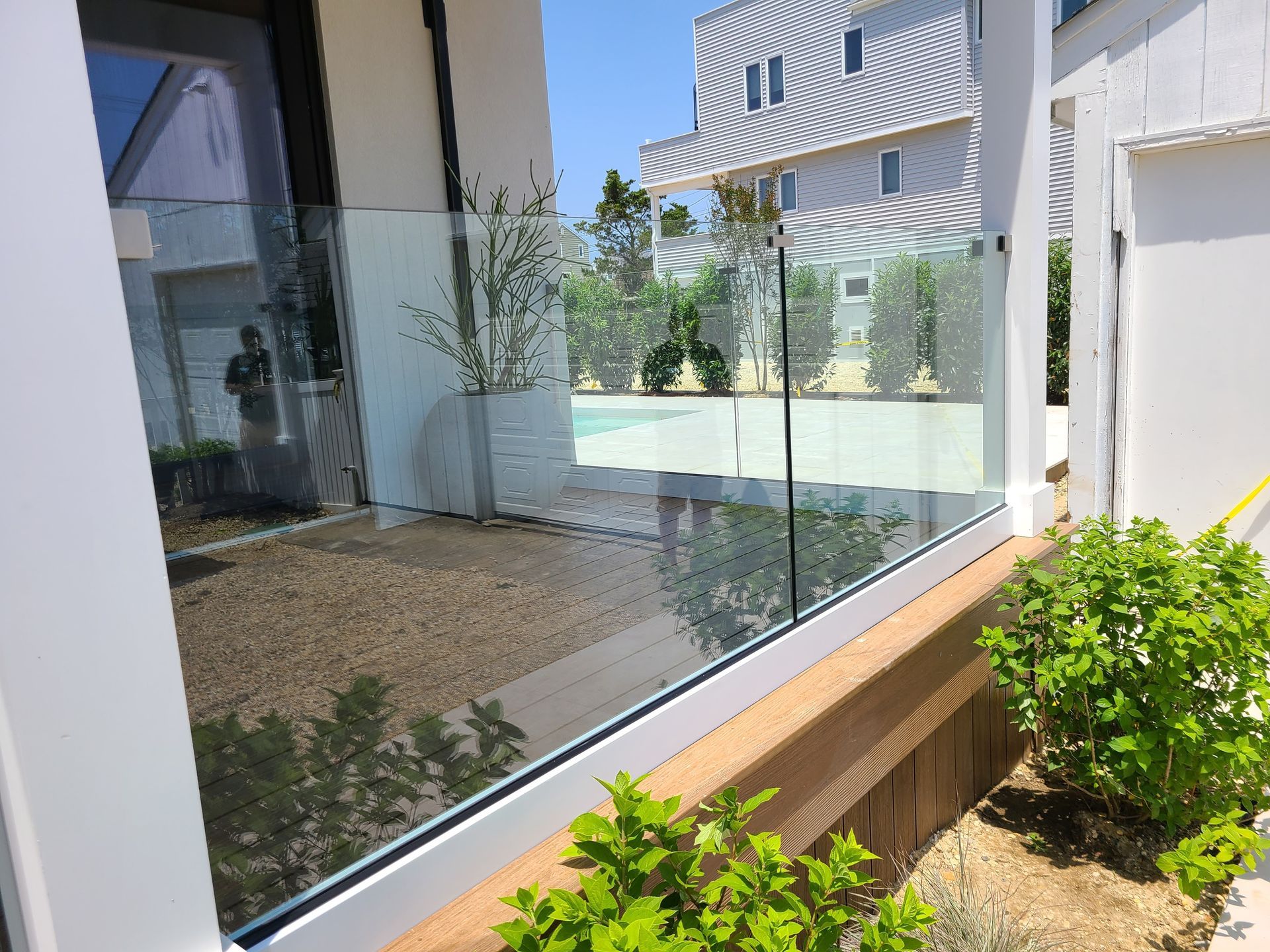 A white house with a glass fence around it