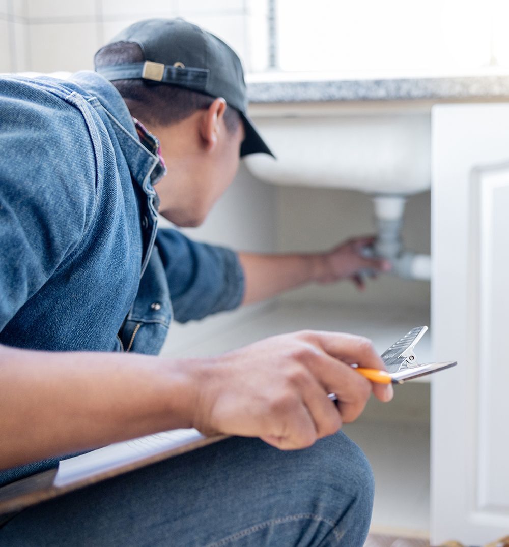 plumber inspecting pipe