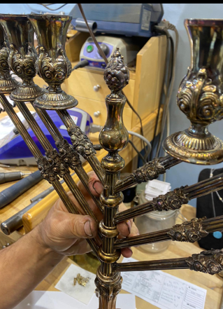 A person is holding a menorah in their hand.