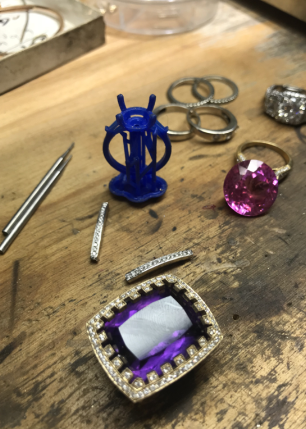 A purple ring is sitting on a wooden table