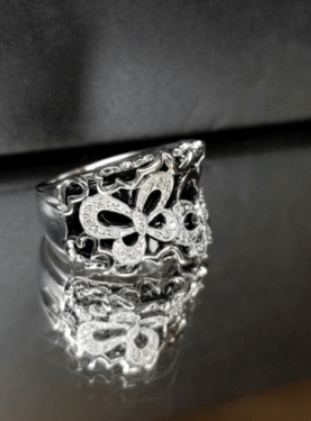 A silver ring with a butterfly design on it