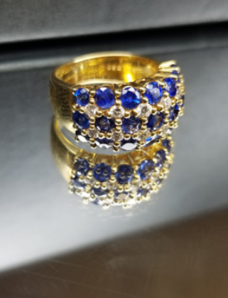 A gold ring with blue sapphires and diamonds