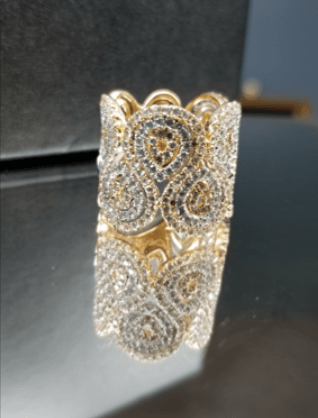 A close up of a gold ring with diamonds on it