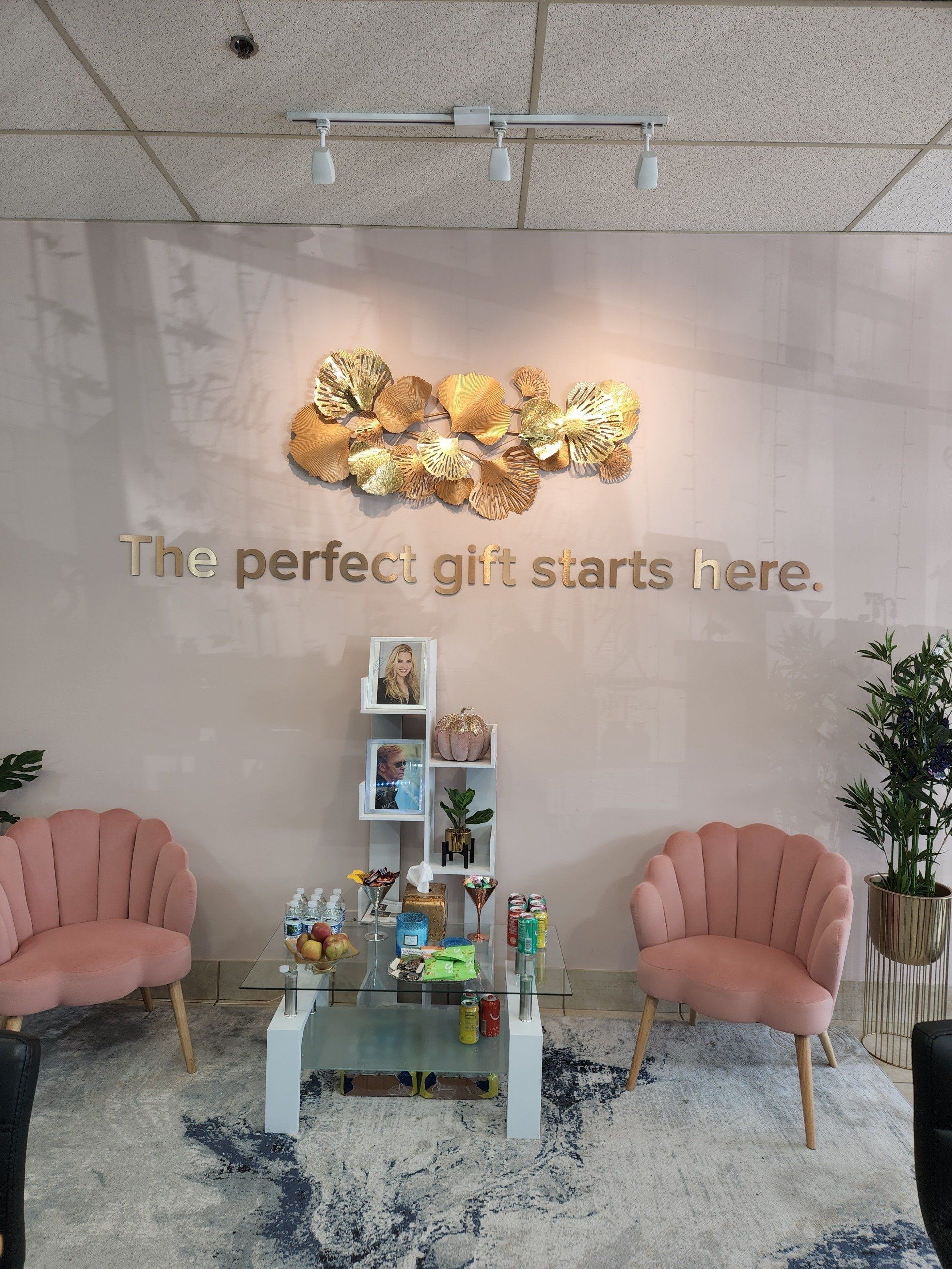 A room with a sign that says the perfect gift starts here