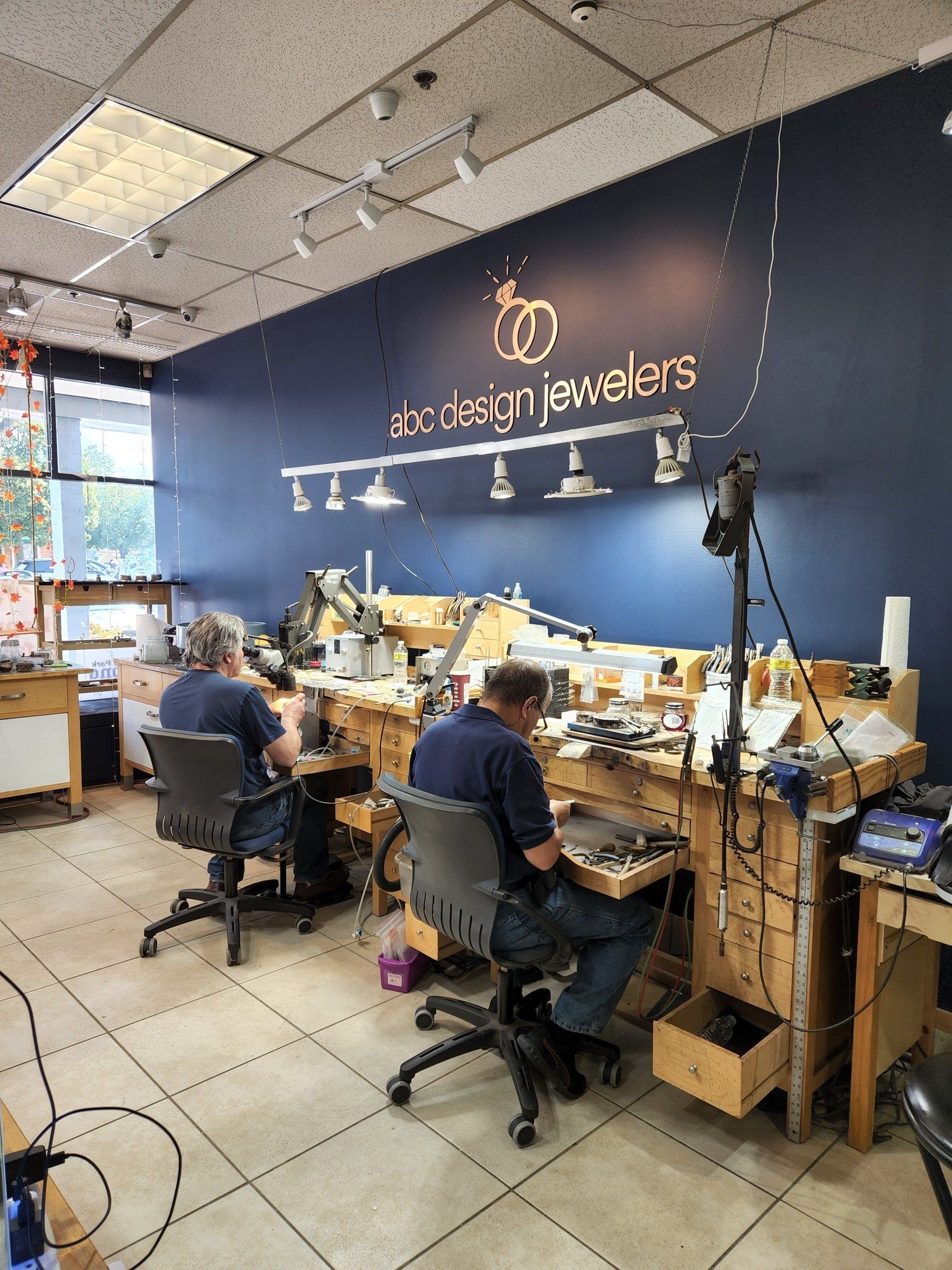 A group of men are working in a jewelry shop.