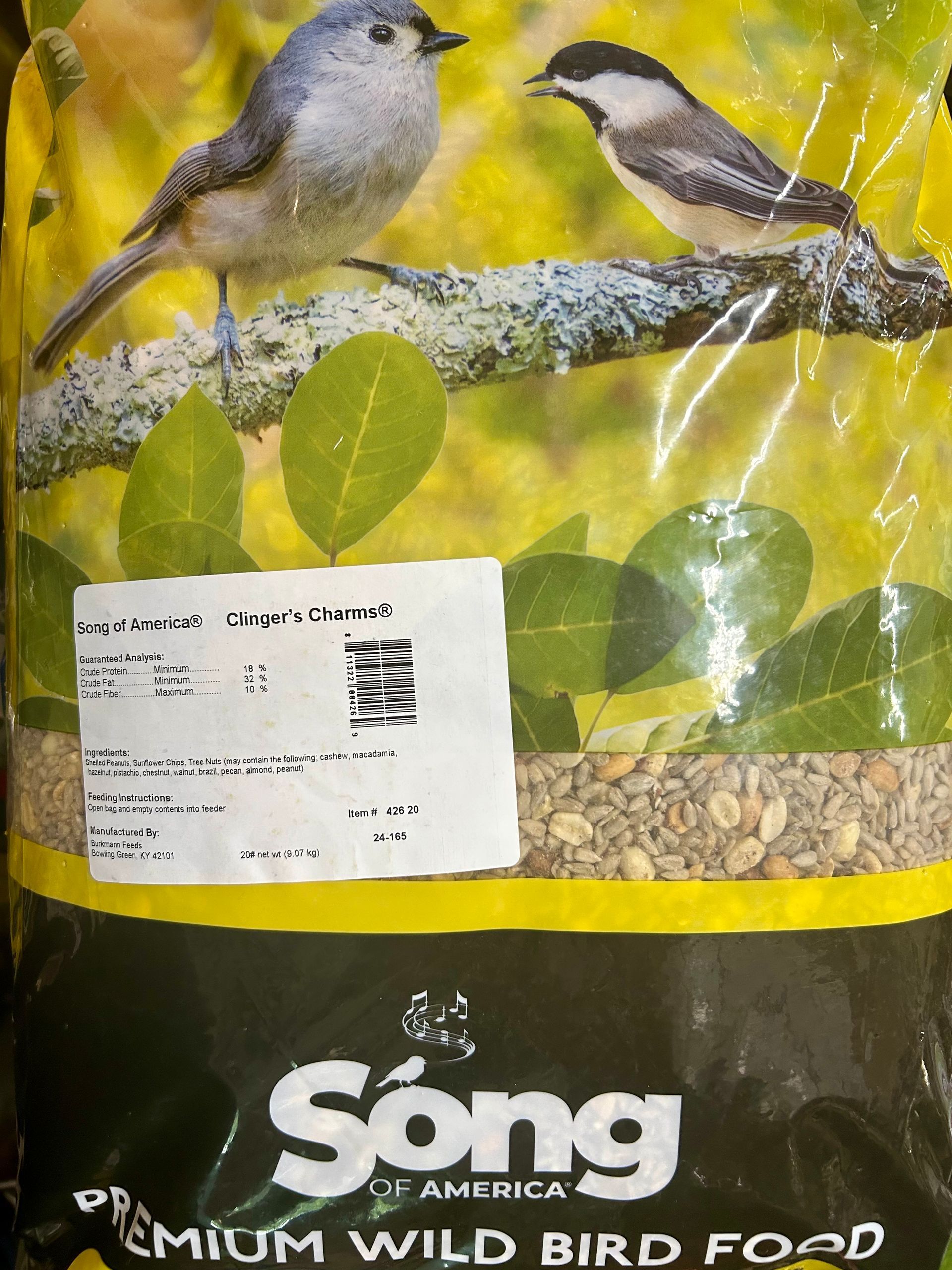 A bag of Song of America premium wild bird food with illustrations of two small birds and a white product label.