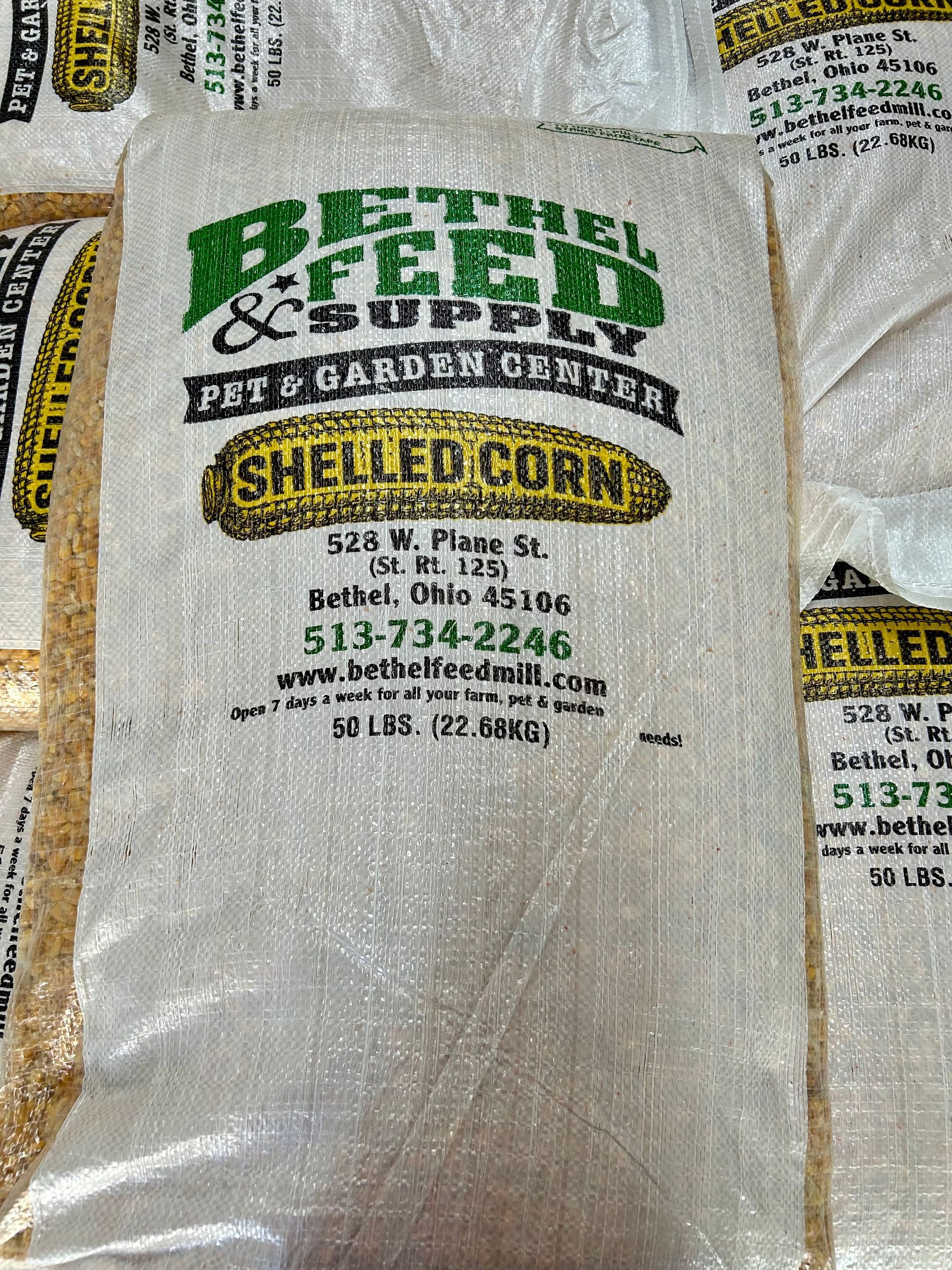A bag of shelled corn is sitting on a table.