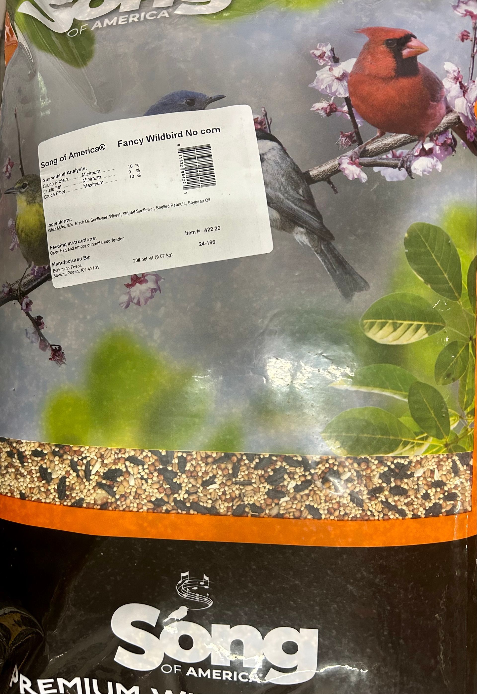 Bag of Songbird food with a cardinal and other birds on the packaging; white label covers part of the image.