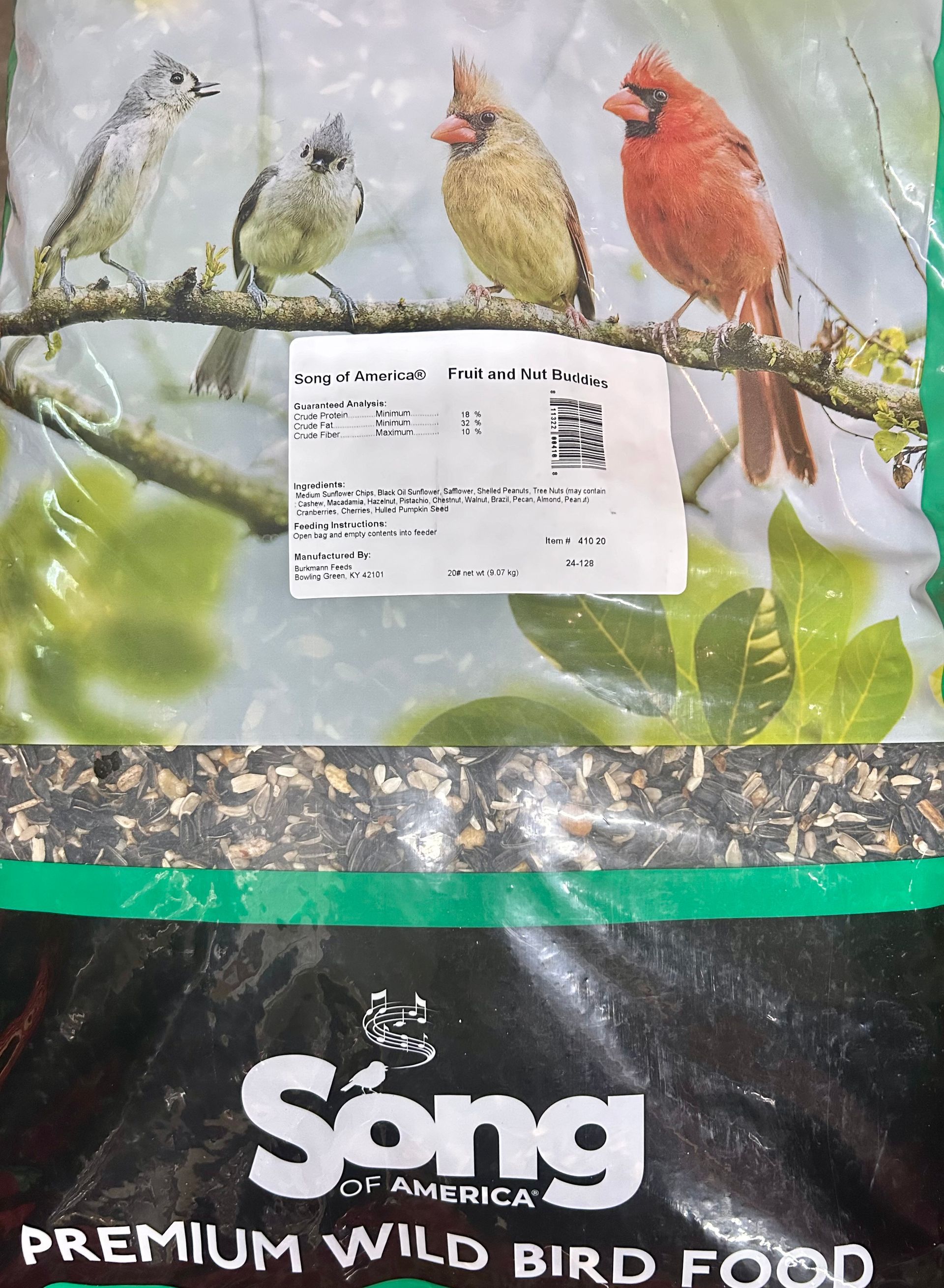 Bag of Song birdseed, with images of various birds on the front. The bag is mostly brown, with a green stripe and the product name.