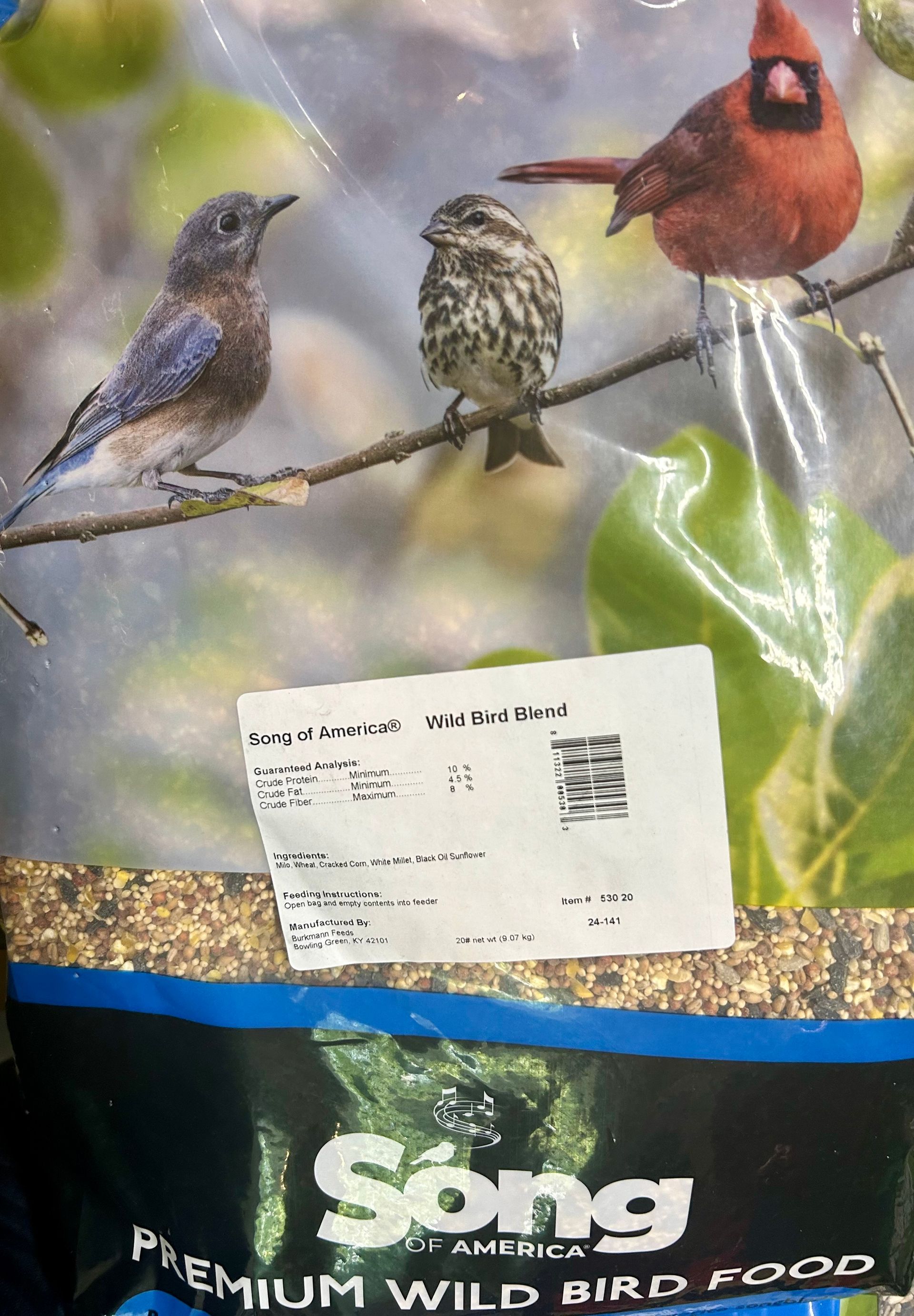 Bag of Song Premium Wild Bird Food. The packaging displays images of a bluebird, a small sparrow, and a red cardinal perched on a branch.