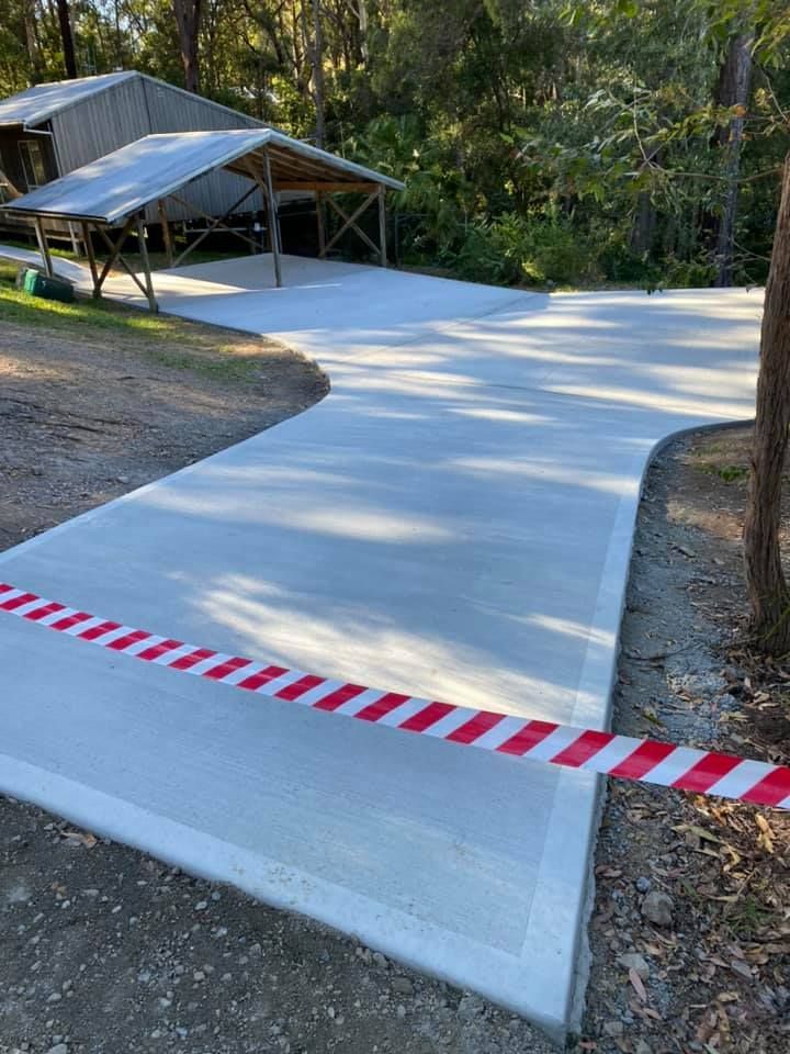New Concrete Driveway With Red and White Caution Tape — Williams Concreting In Taree, NSW