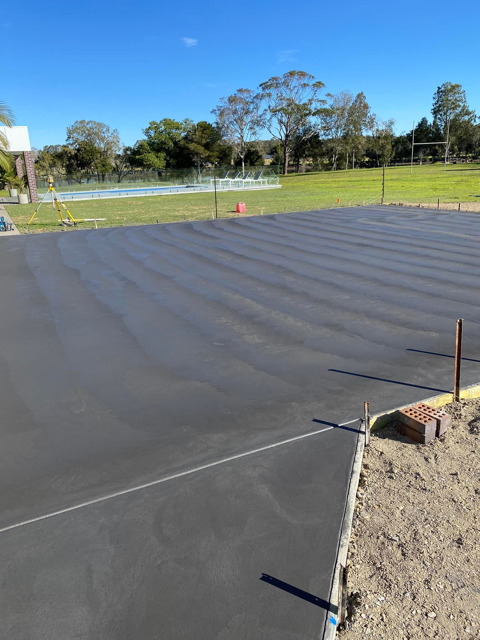 Newly Paved, Dark Gray Asphalt Surface With Textured Grooves — Williams Concreting In Taree, NSW
