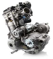 A close up of a motorcycle engine on a white background.