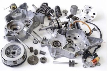 A bunch of motorcycle engine parts on a white surface