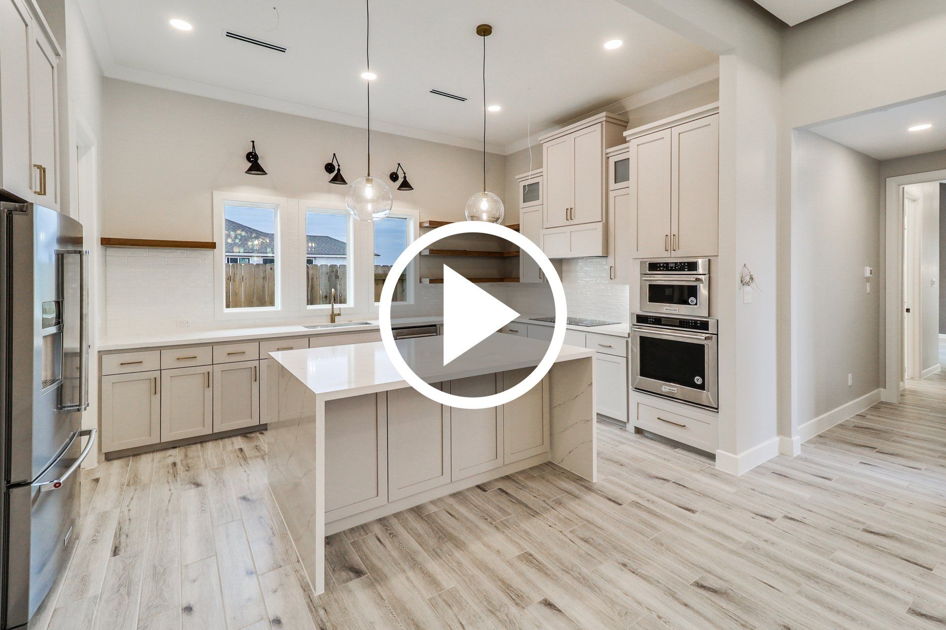 Brito Construction Home Tour Video elegant modern kitchen with button to play video