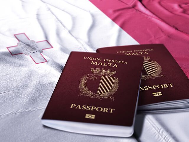Two Maltese passports on a flag.