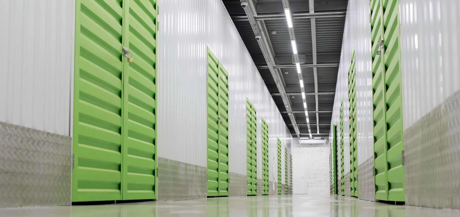 a hallway with green doors and white walls
